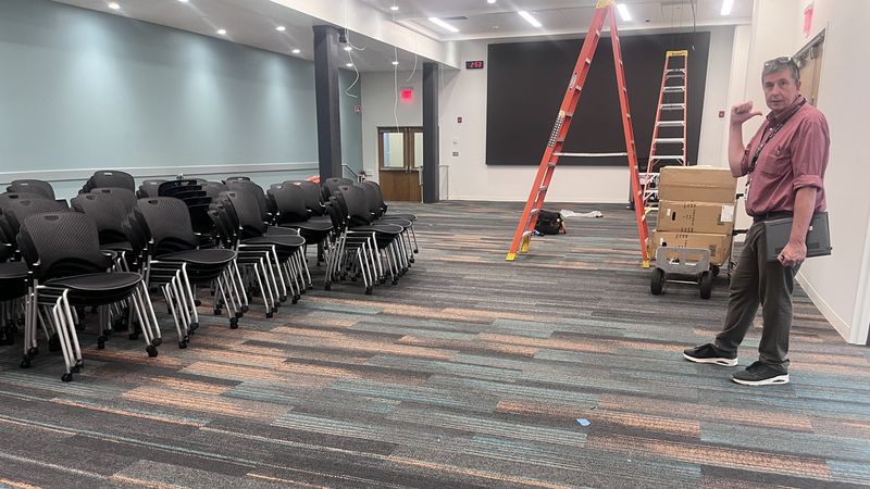 MCPHS Room, White 101 with chairs and screen and Tom Scanlon.