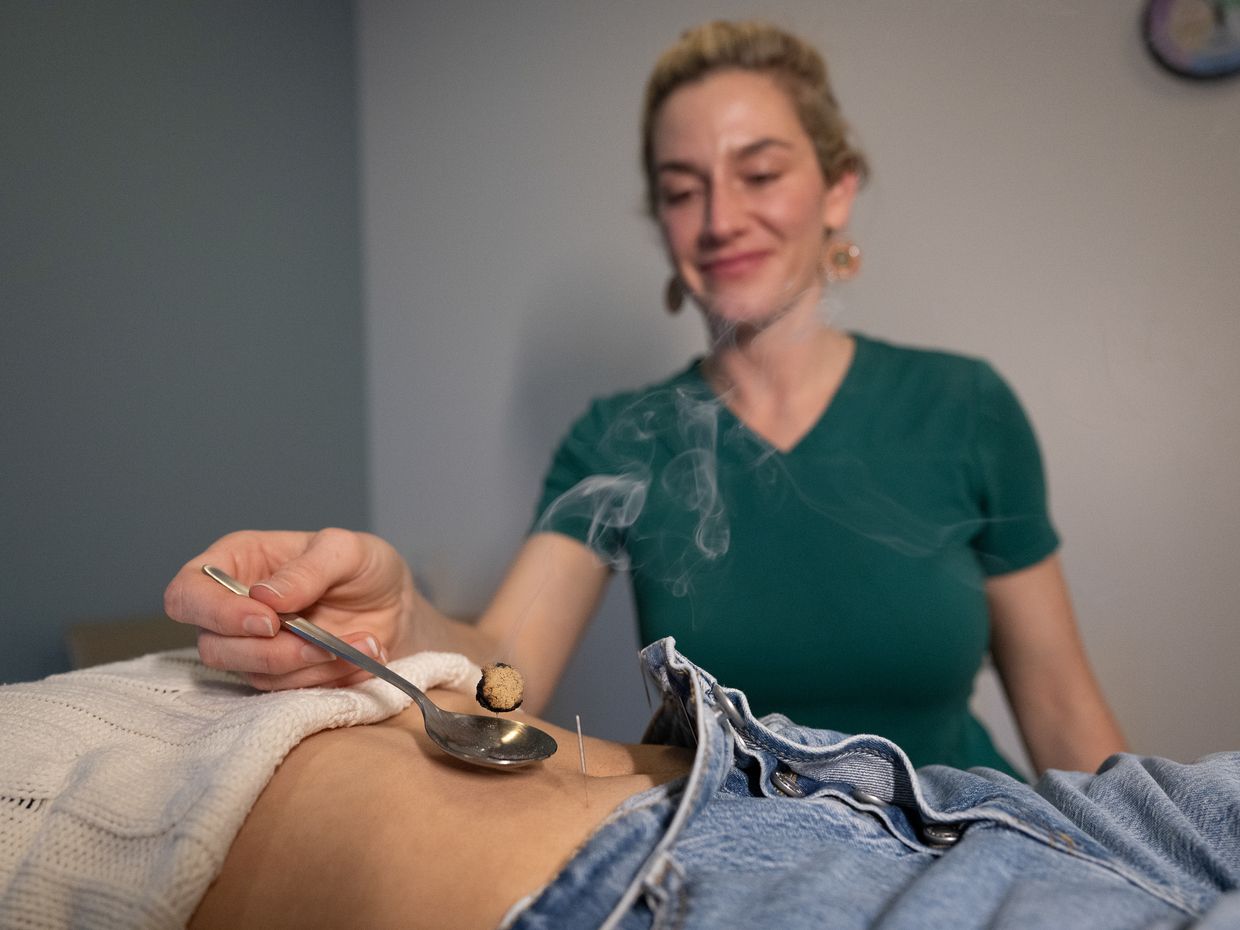 Students and faculty collaborating in the NESA acupuncture clinic on the MCPHS Worcester campus. 