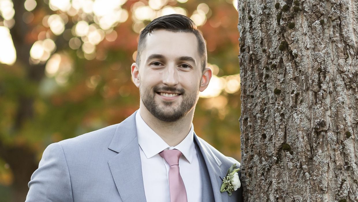 Michael Soden standing next to a tree.