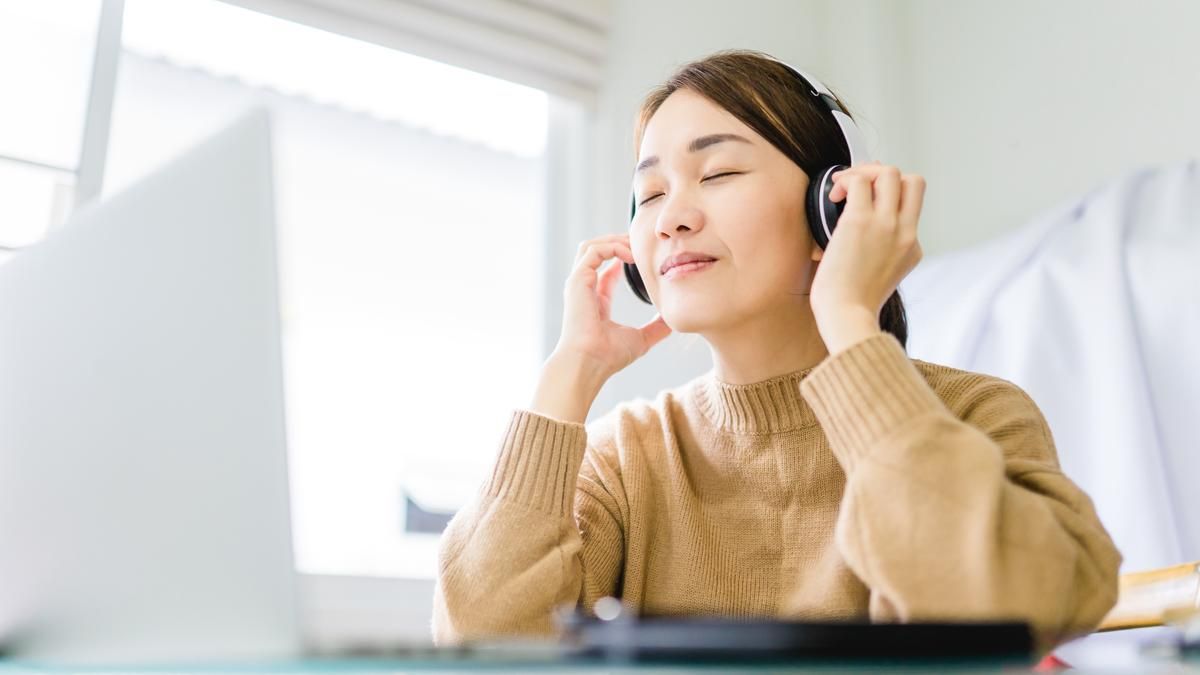 Female with headphones on smiling. 