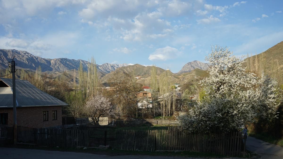 A village in Kyrgyzstan nestled between massive mountains.