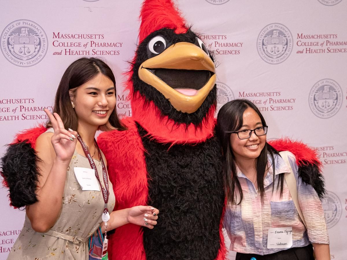 two female students posing with Red the Cardinal