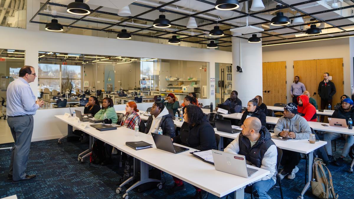 Students in a classroom listening to professor.