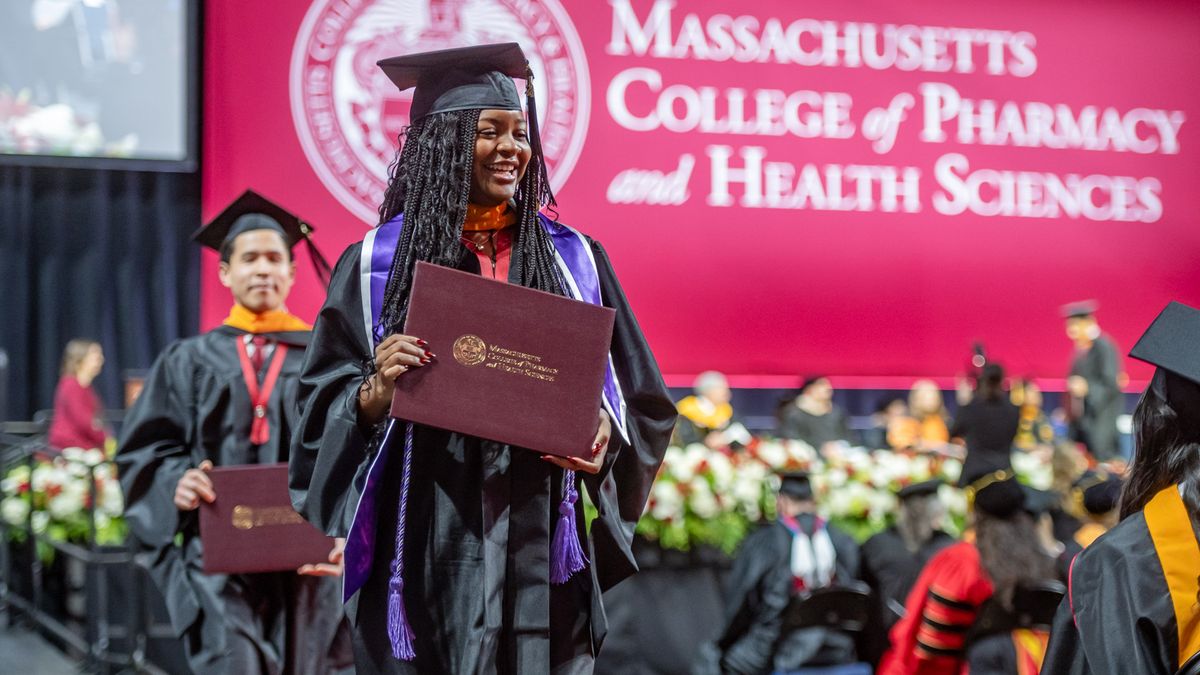 Students in cap and gowns at Commencement. 