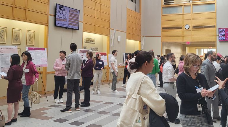 People standing at the MCPHS Student Research Conference.