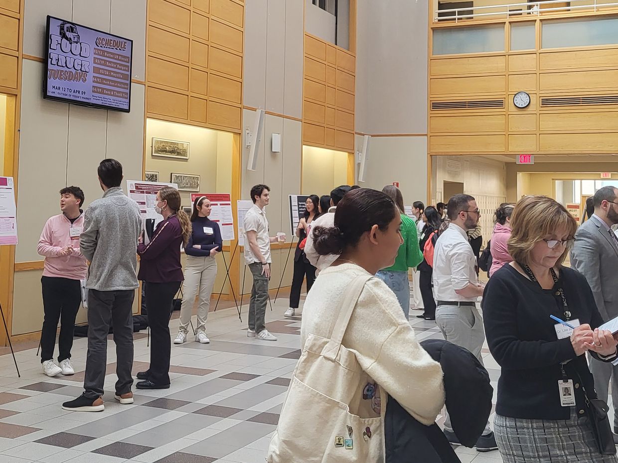 People standing at the MCPHS Student Research Conference.