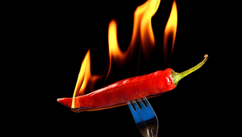 Chile pepper on fire on a fork. 