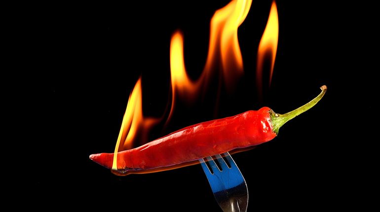 Chile pepper on fire on a fork. 