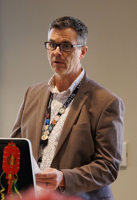 Dennis Moseman addresses people from a podium.