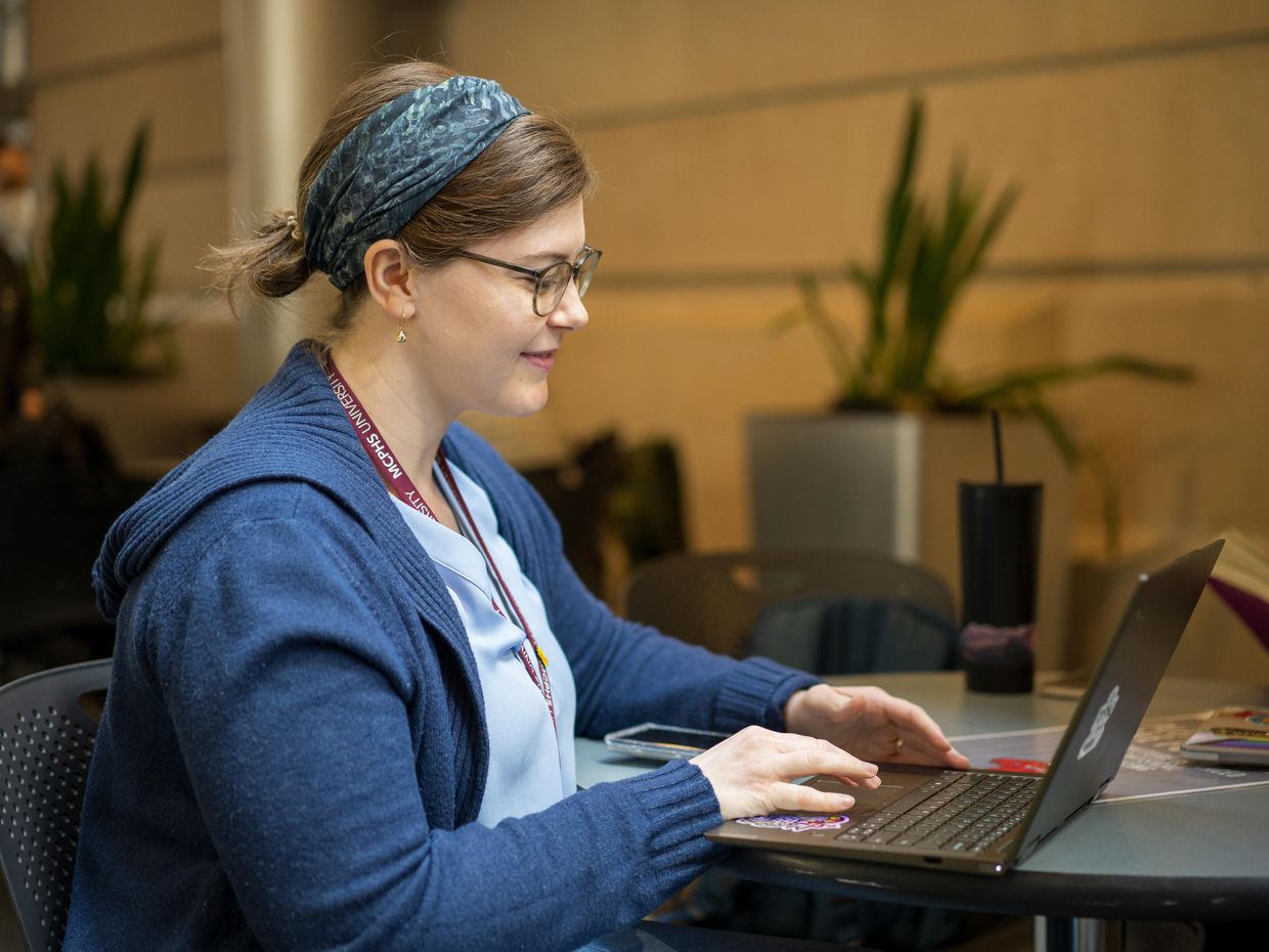 Female student with laptop. 