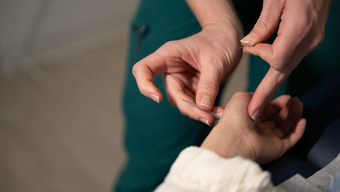 Students and faculty collaborating in the NESA acupuncture clinic on the MCPHS Worcester campus. 
