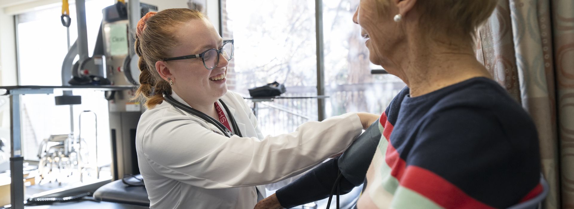 Physical Therapy students working with patients in lab setting