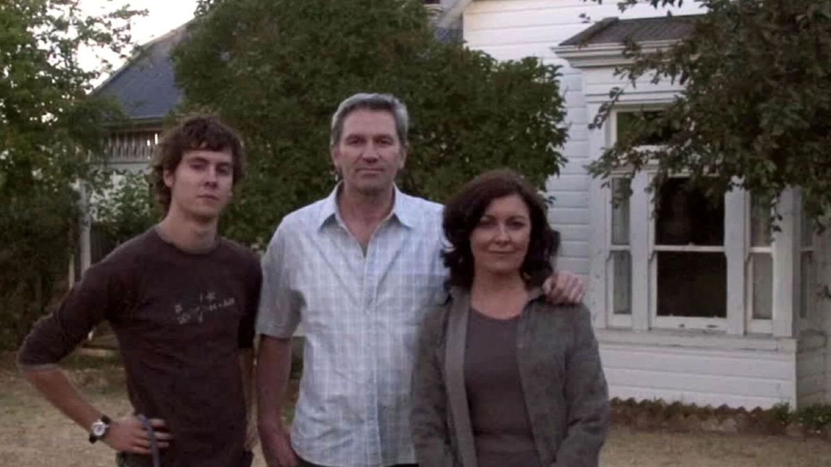 People stand in front of a house.