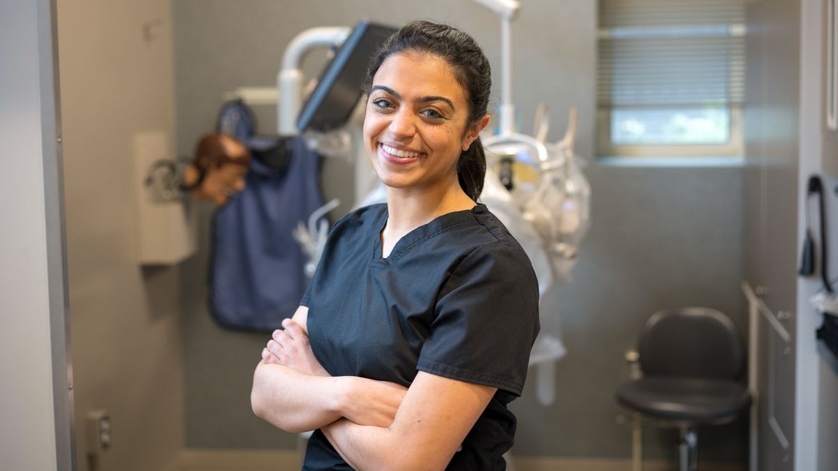 Smiling MCPHS Dental Hygiene student in the Boston Forsyth Dental Hygiene Clinic. 