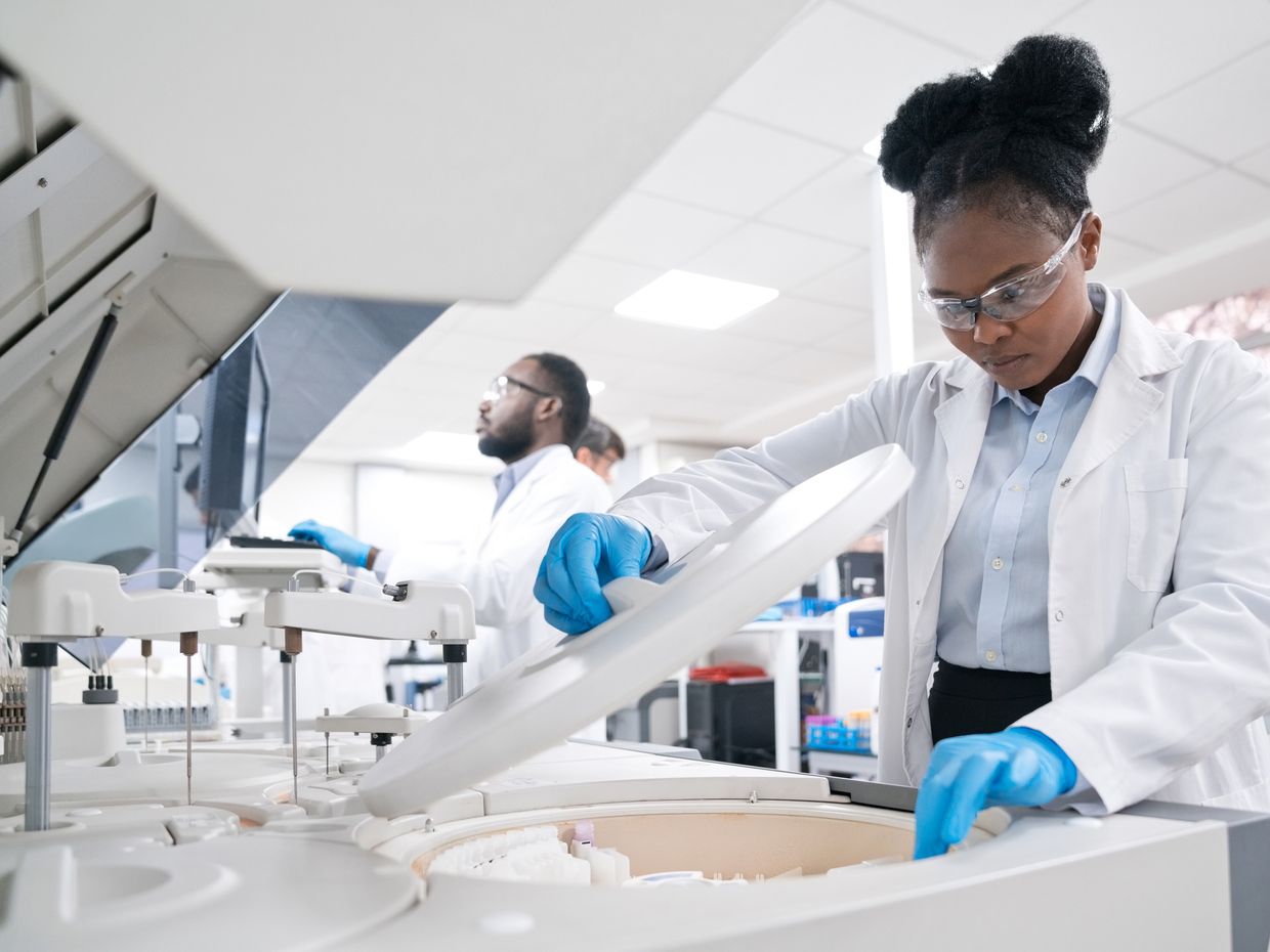 Female medical worker wearing lab coat while working in laboratoryFemale medical worker wearing lab coat while working in laboratory