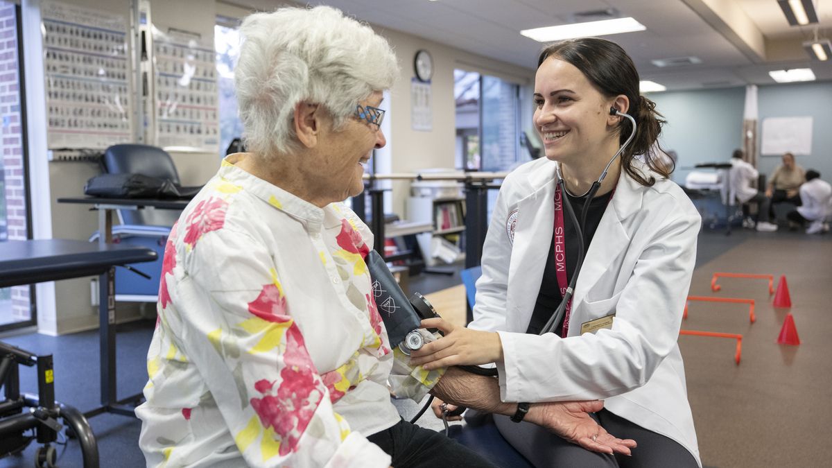 Physical Therapy students working with patients in lab setting