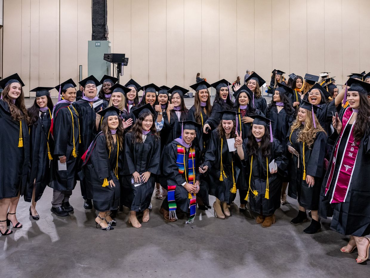 Students in cap and gowns at Commencement. 