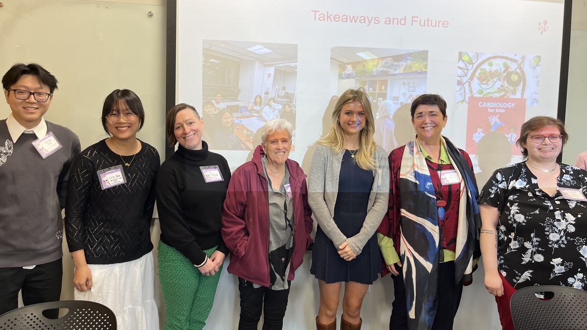 People standing in front of a screen.