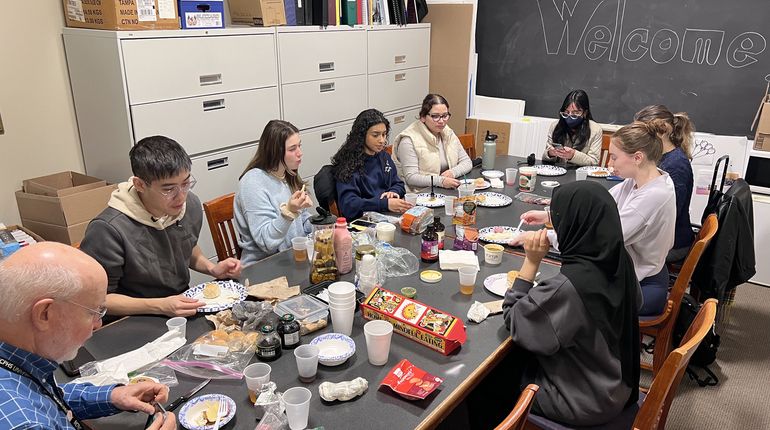 Students sitting at a table in a classroom.