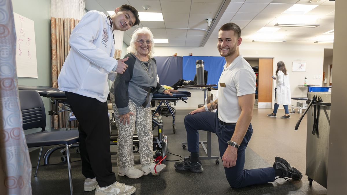 A Physical Therapy student and professor working with patient in the Balance, Movement, and Wellness Center.