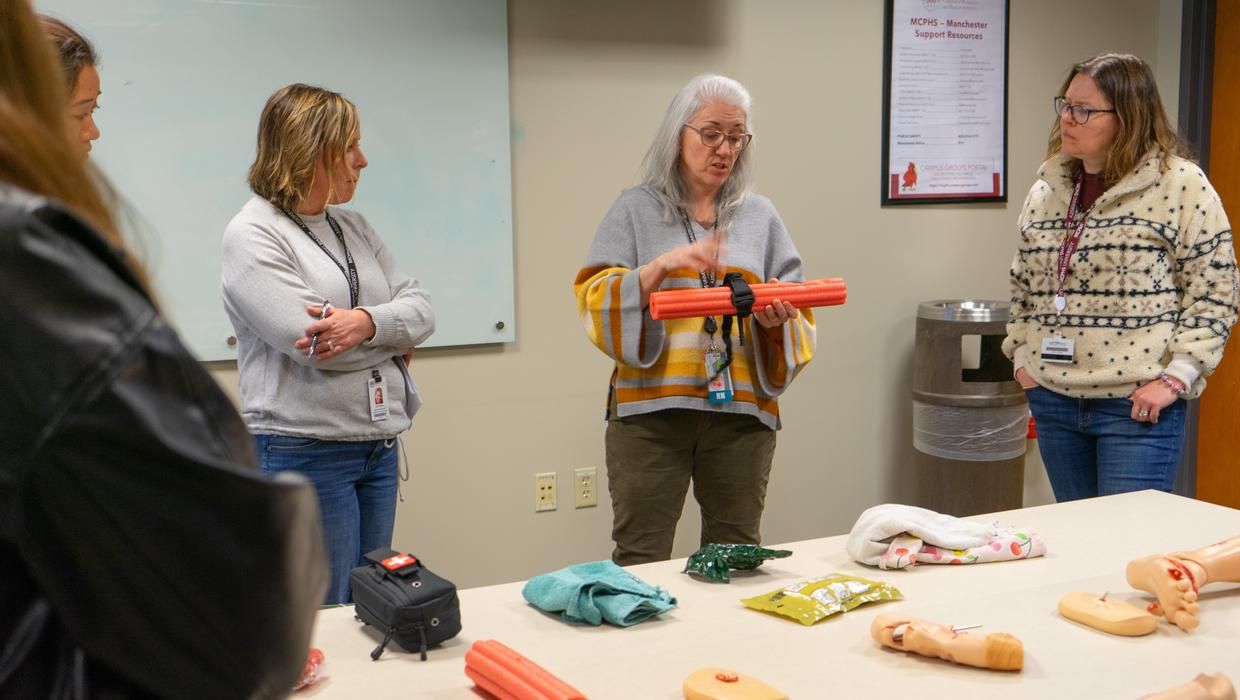 Assistant Professor Carla Smith leads students in the Postbaccalaureate Bachelor of Science in Nursing program in Manchester through “Stop the Bleed” training. 
