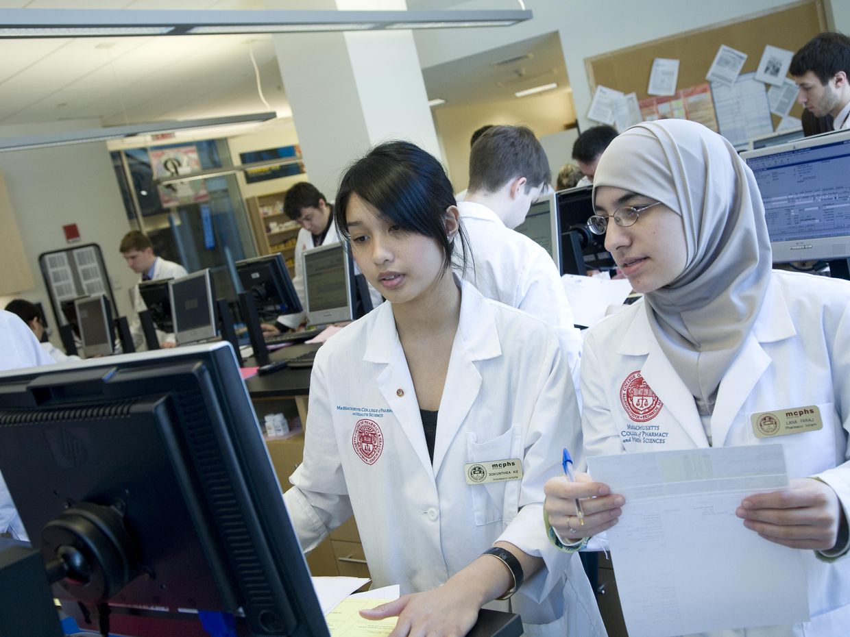 Two female students in the pharmacy lab. 