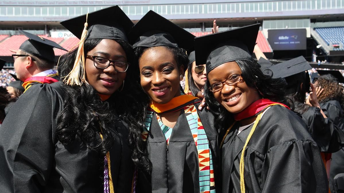 Three female students at Commencement