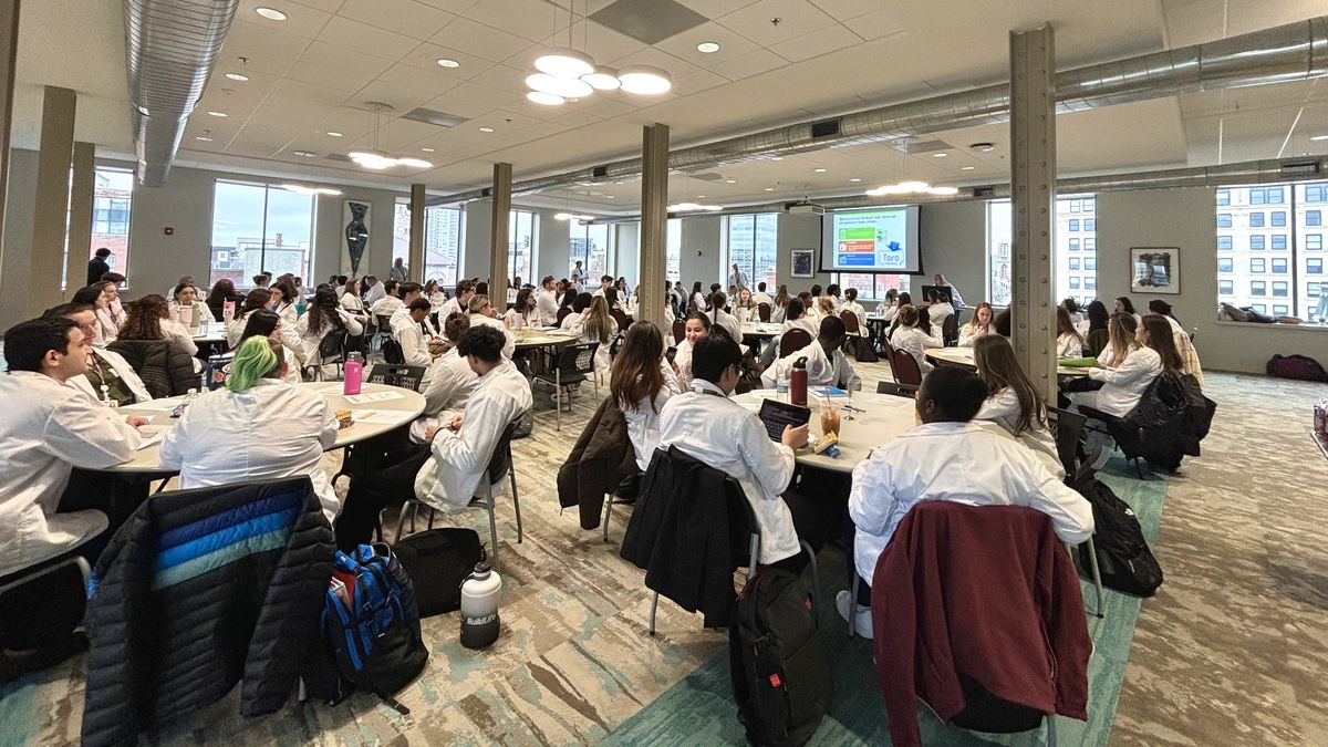 Students sitting at tables in a room.