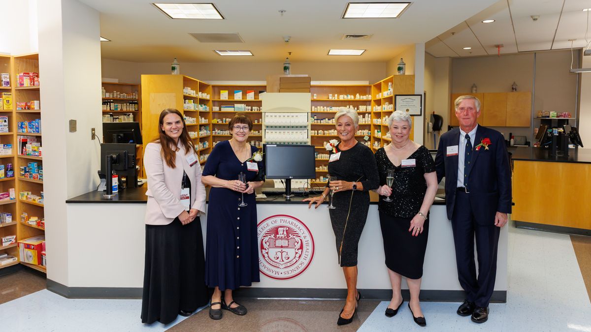 Poeple pose in the MCPHS pharmacy lab.