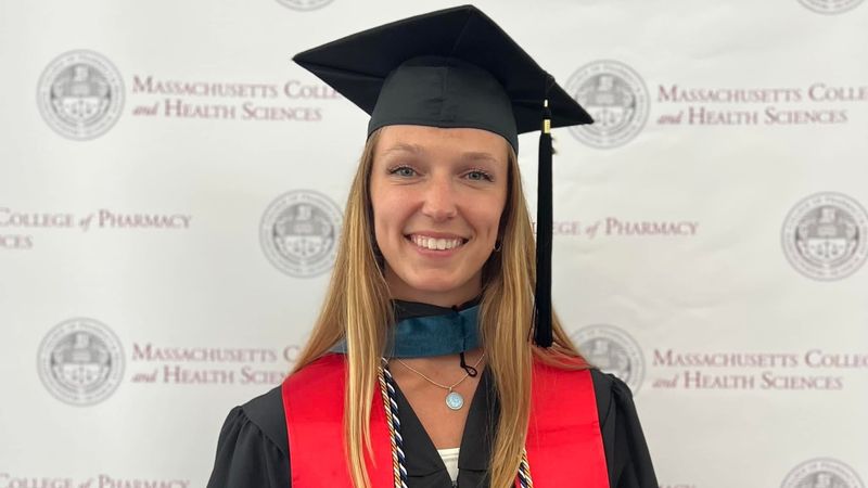 Abbie McCaffrey in a cap and gown after graduating from the Master of Occupational Therapy (MSOT) program at MCPHS.