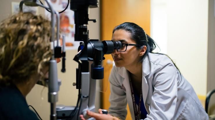 Female optometry student working with patient. 