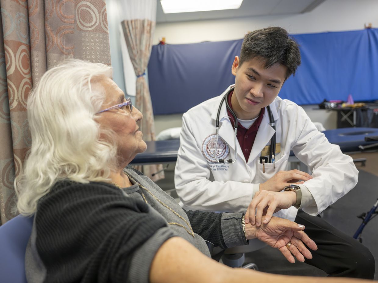 Physical Therapy students working with patients in lab setting