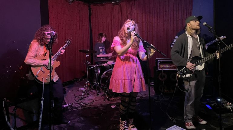 Kathryn Day sings on stage with her band.