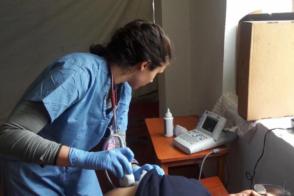 MCPHS student performing an ultrasound on a patient in Bolivia